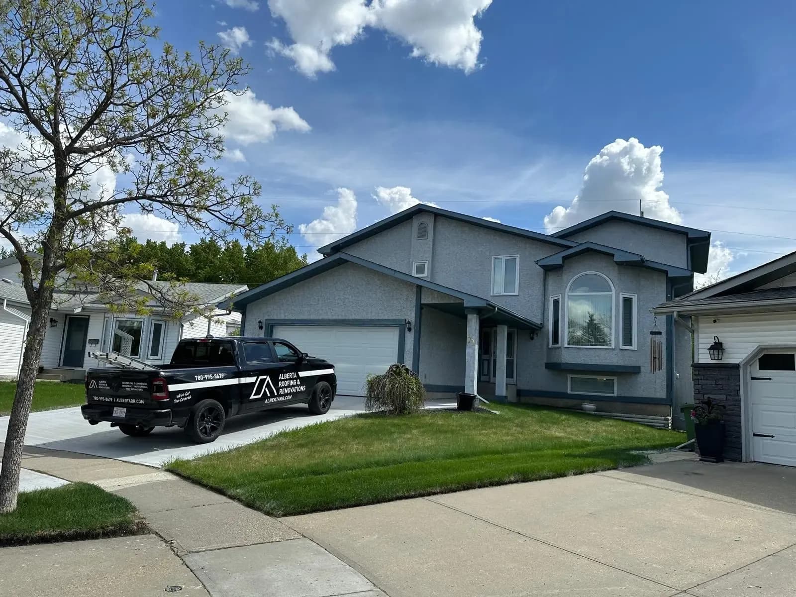 Home with a new roof and the company truck in the driveway
