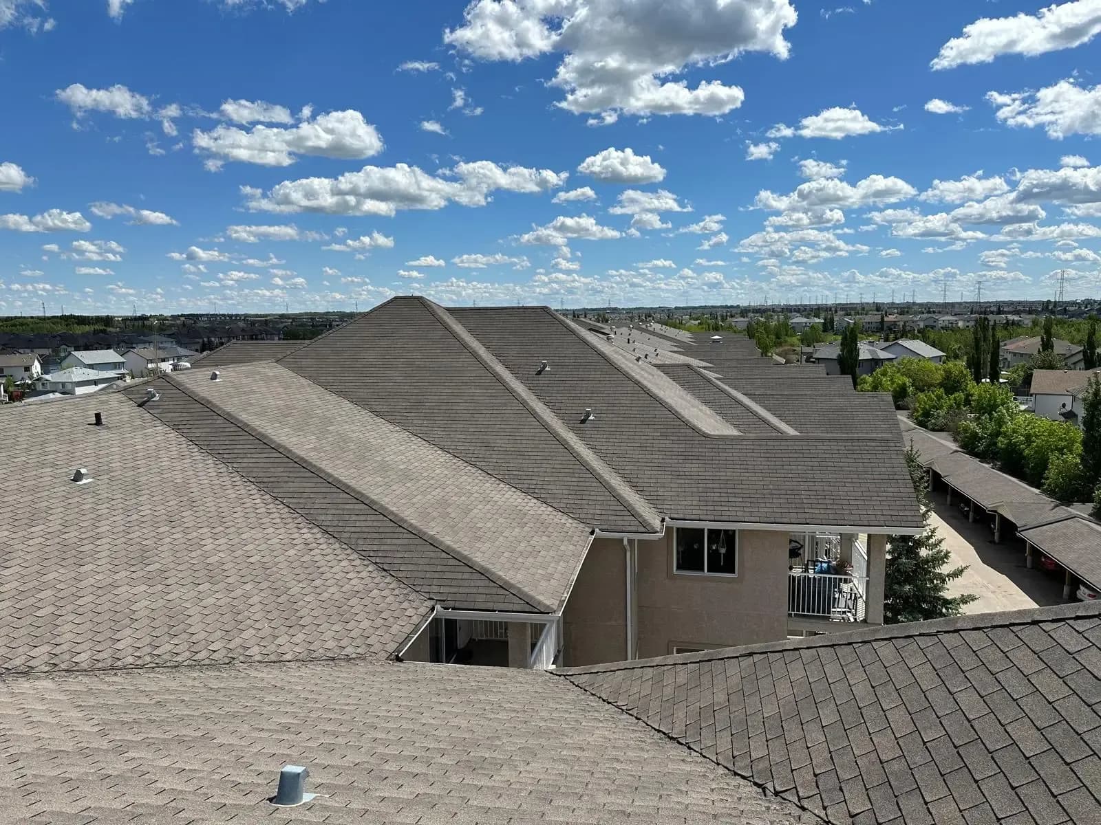 New brown shingle roof on a multi-family building